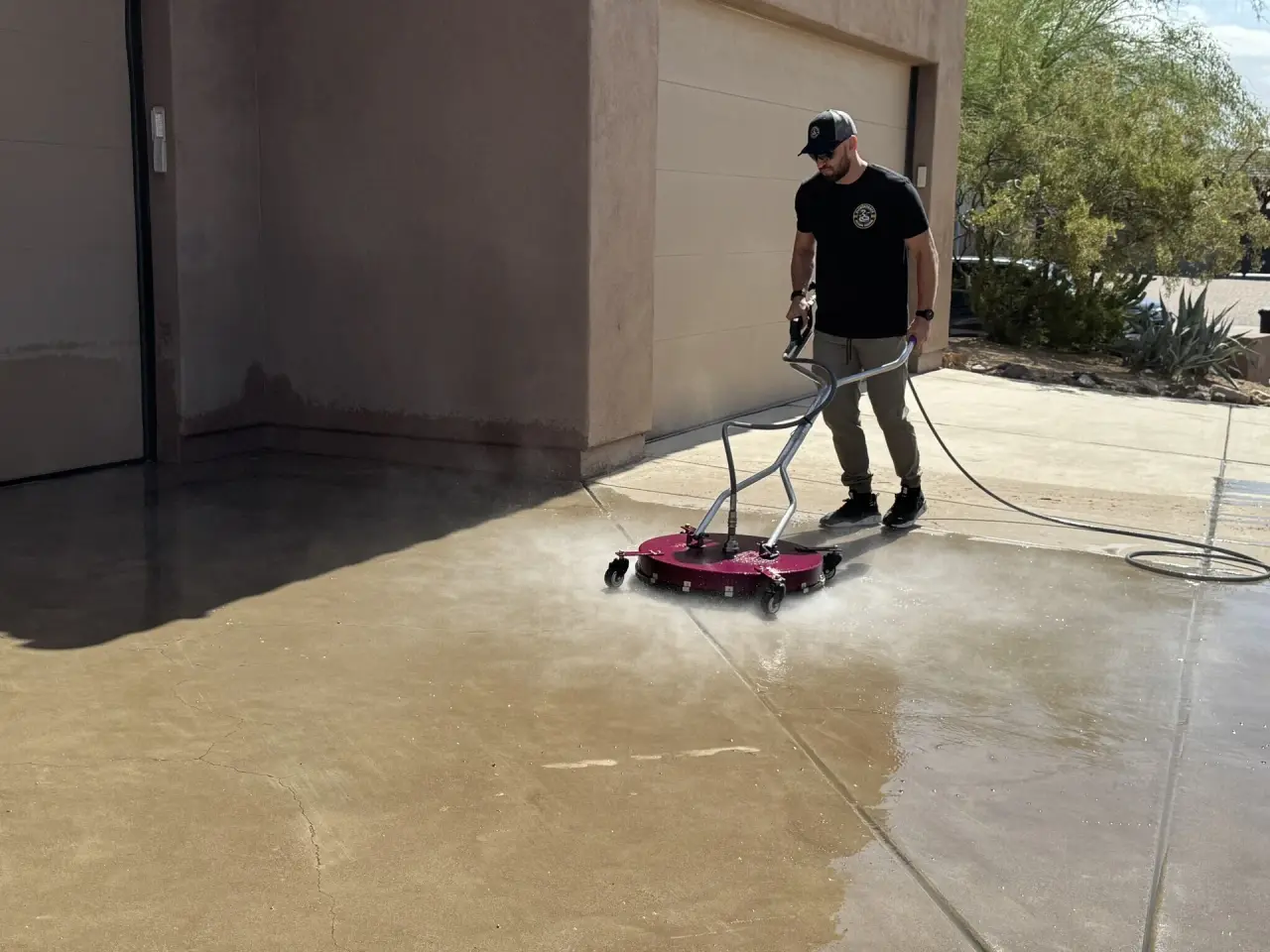 Surface cleaner restoring a concrete driveway in Gilbert, Arizona