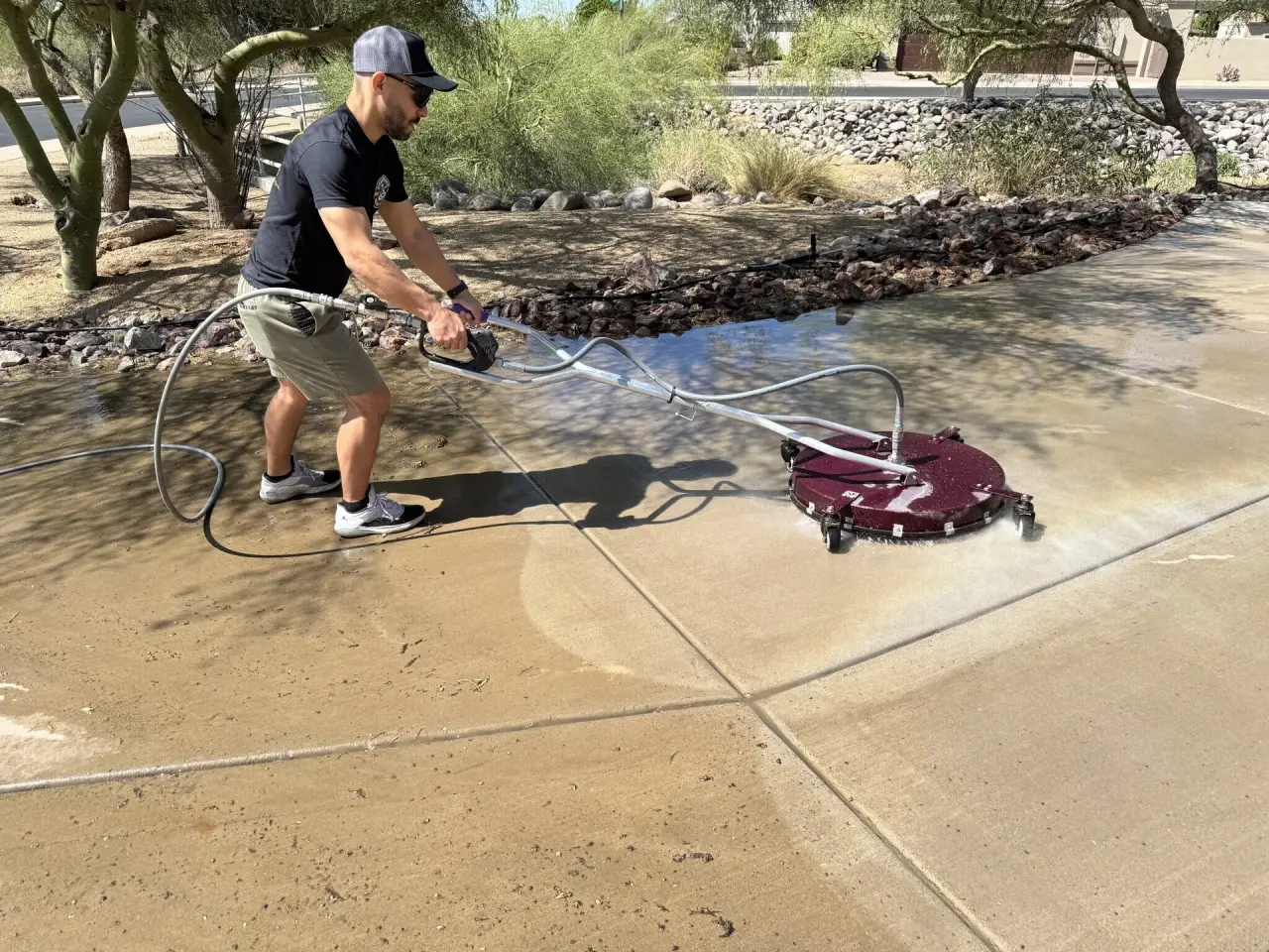 Pressure washing mist drifting across Arizona backyard at sunrise