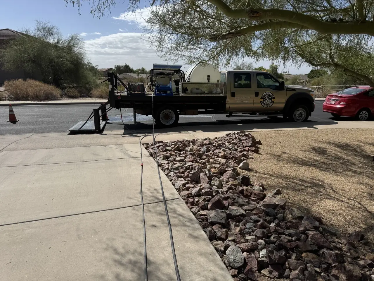 Professional pressure washing spray hitting concrete surface in Arizona